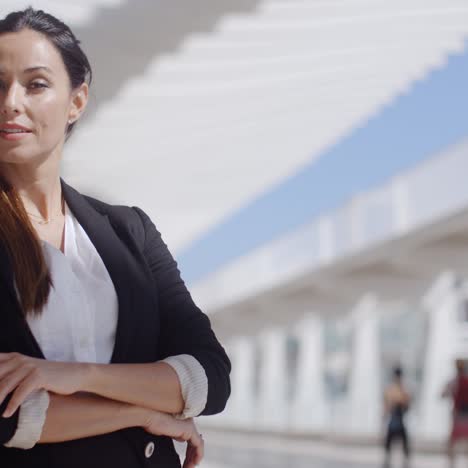 Thoughtful-businesswoman-with-folded-arms