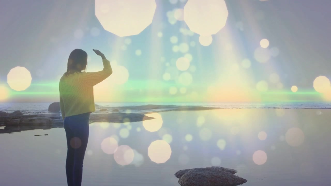 Donna che si volta, riparandosi gli occhi dal sole che si avvicina all'orizzonte, con effetti bokeh e bagliori intorno a lei, per la sua salute.