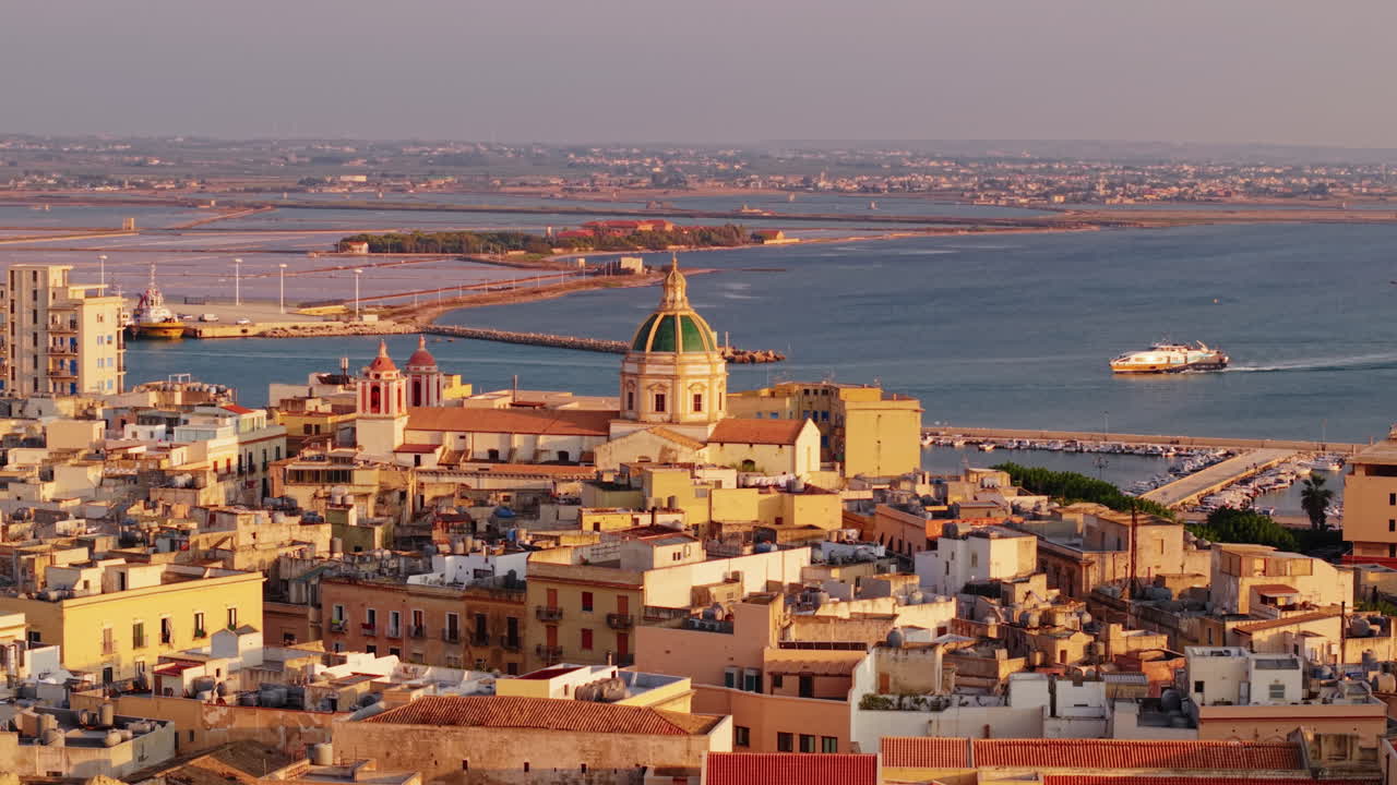 Scenic view of Trapani, Sicily at sunset with historic buildings by the sea