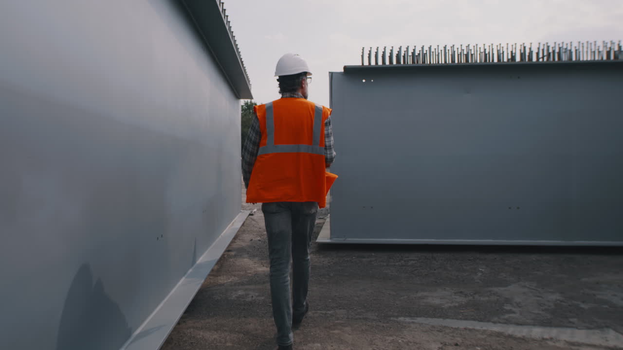 Construction worker inspecting steel beams on a bridge construction site