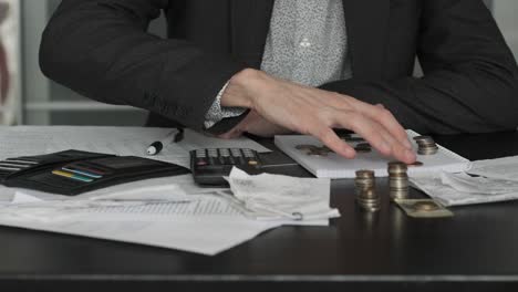 businessman distributing budget by counting coins