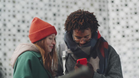 couple looking at a phone outdoors