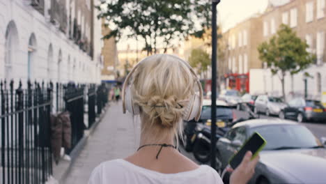 beautiful blonde listening to music in the city