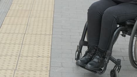 disabled lady with a cell phone and a protective mask.