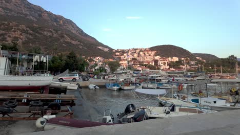 stunning panoramic view of kaş marina, showcasing boats, clear water, and surrounding mountains. captures the charm of coastal turkey.