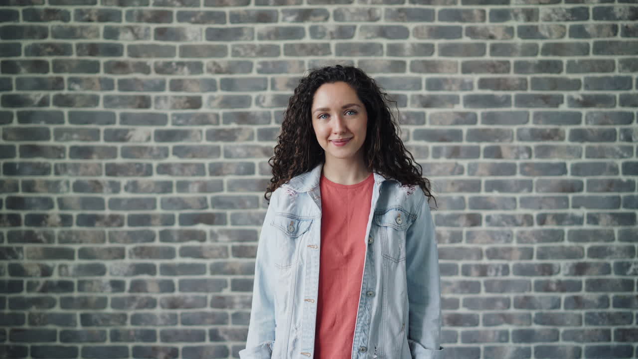 Woman wearing denim jacket and red shirt