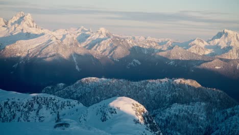 telephoto footage of a snowy mountain range in bc, canada