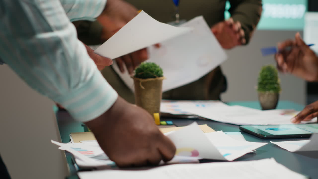 Multiethnic team reviewing analytics in a late night company briefing