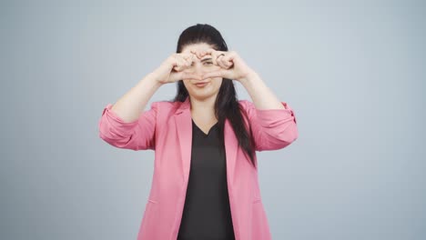 business woman making heart at camera.