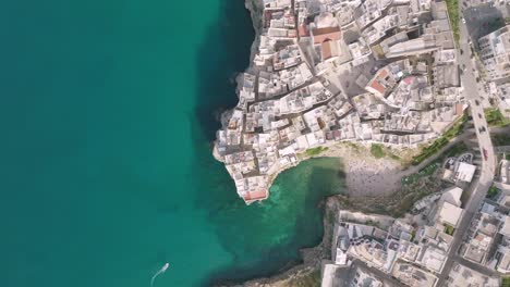 wide aerial top down footage of polignano a mare in italy