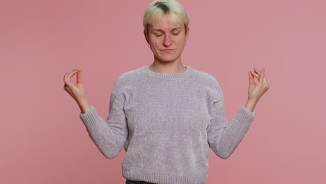 woman breathes deeply with mudra gesture, eyes closed, meditating with concentrated thoughts alone