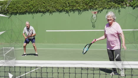 senior couple playing tennis outdoors, with animated sports graphics showing rackets, net and hoop