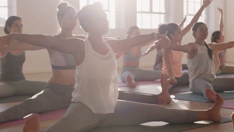 yoga class of beautiful multi ethnic women practice seated side bend pose enjoying healthy lifestyle exercising in fitness studio group meditation at sunrise