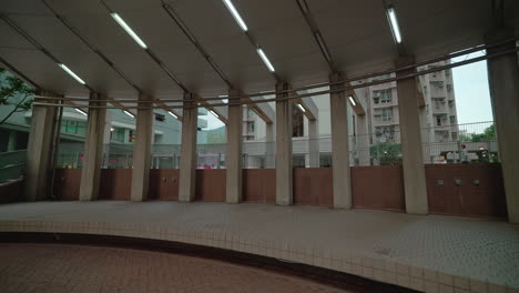 a cinematic aerial pull back establishing shot of an outdoor open auditorium of a residential society