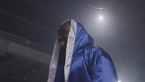 a confident boxer smiling in the ring