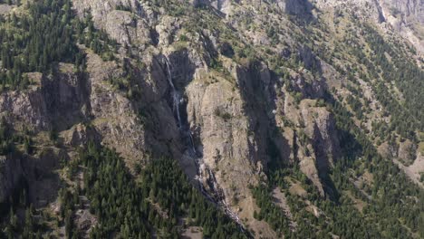 Majestic-drone-shot-of-a-waterfall-on-the-cliffs-of-the-Verdon-Gorge-in-France