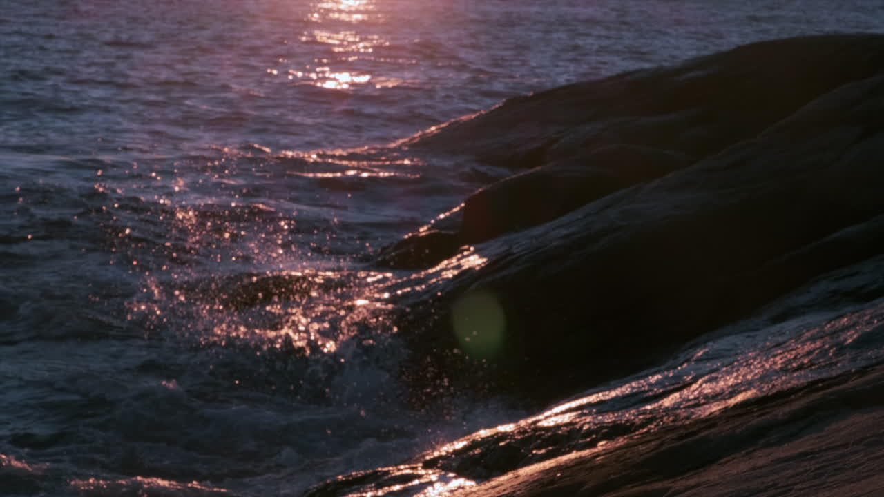 Mysterious Dark Ocean Rippling At Beautiful Golden Sunset Slow motion