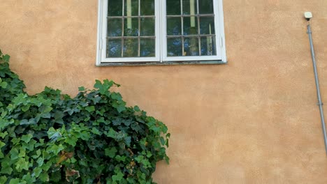 4K-60FPS-Close-up-View-of-Swedish-Church-Wall-With-Old-Windows---Tilt-Shot