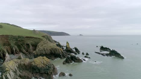 Aerial-tracking-over-a-rugged-rocky-remote-English-coastline