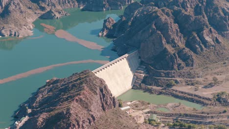 aerial view of valle grande dam and reservoir in mendoza, argentina, renewable hydropower infrastructure