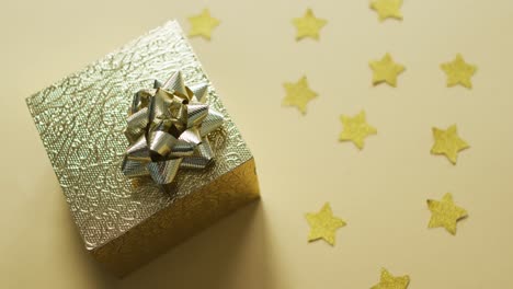 video of christmas decorations with gold present on green background