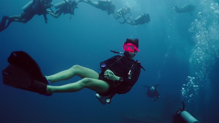 Group of Scuba Divers Exploring Underwater