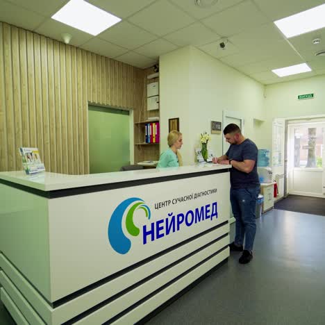 visit to the doctor. man coming into the modern hospital. patient waiting for the doctor at the reception room. health care concept.