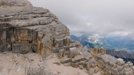 forward aerial view of magnificent dolomite valley through a close up of mount pelmo