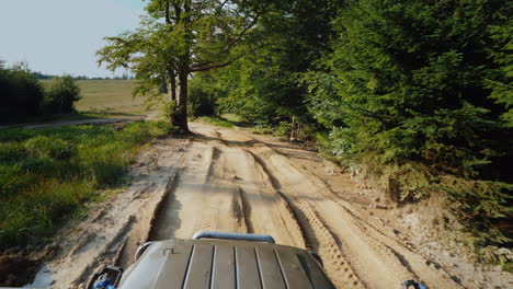 suv rides on an extremely bad dirt road a top view stabilized on 3 axes shot