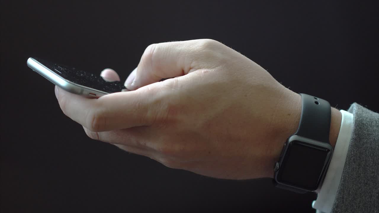 hombre usando un teléfono inteligente y usando un reloj