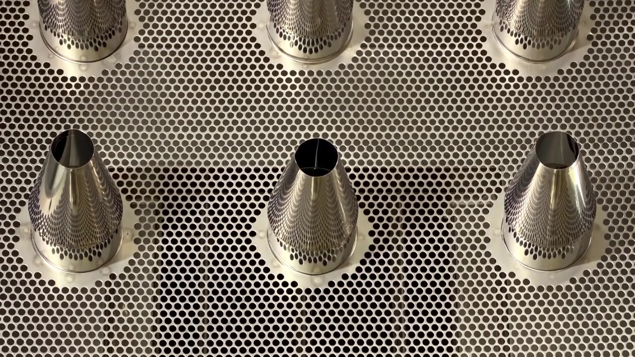 Industrial stainless steel panel with three control valves for machinery operation.
