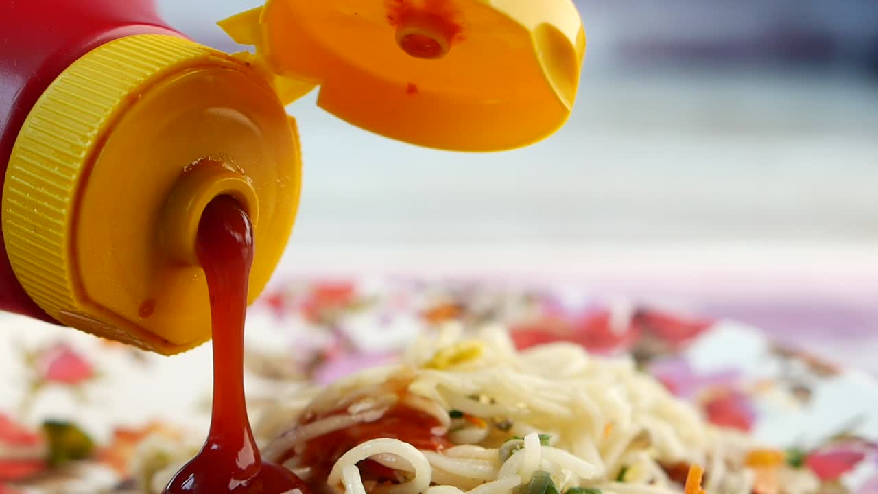 Pouring Ketchup on Spaghetti