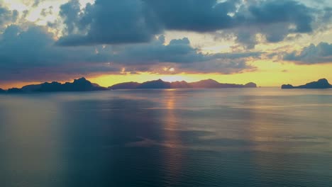 aerial of sunset over the sea at las cabanas beach, el nido, palawan, philippines