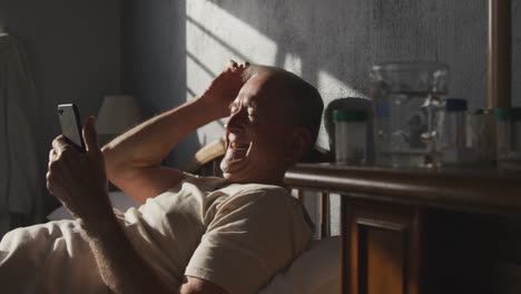 Senior-man-using-digital-tablet-on-bed