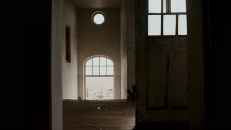 abandoned building interior with sunlit corridor