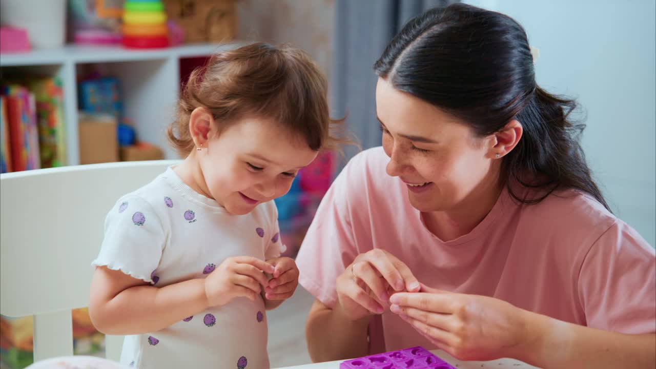 Joyful Moments of Creativity: A Mother and Her Toddler Engaged in Playful Crafting and Bonding Time at Home, Celebrating the Wonders of Childhood Through Art