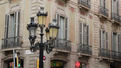 street lamp against business building in the street of la rambla in barcelona, spain at broad daylight