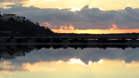 Right-Pan-de-las-Salinas-de-Ibiza-with-sunrise-lights-reflected-in-the-water,-Ibiza,-Spain