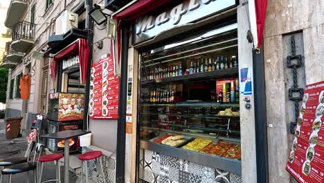 a bustling food shop on a naples street