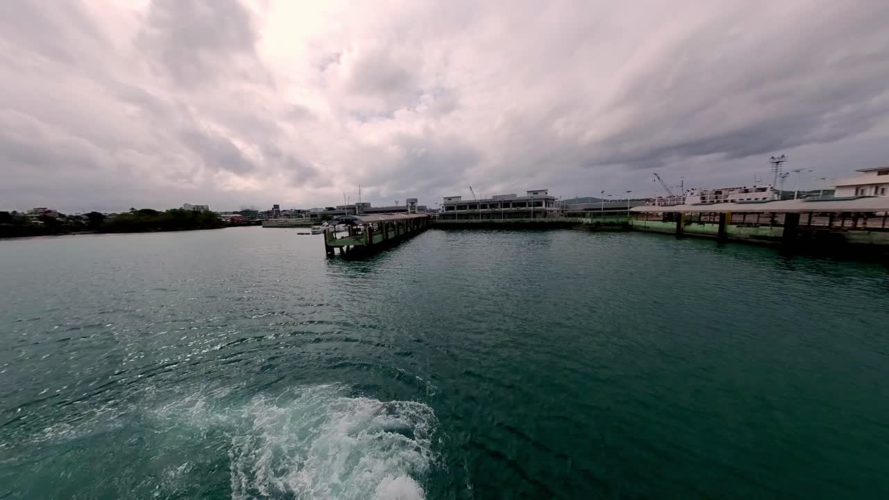 View of a pier from the sea under cloudy skies