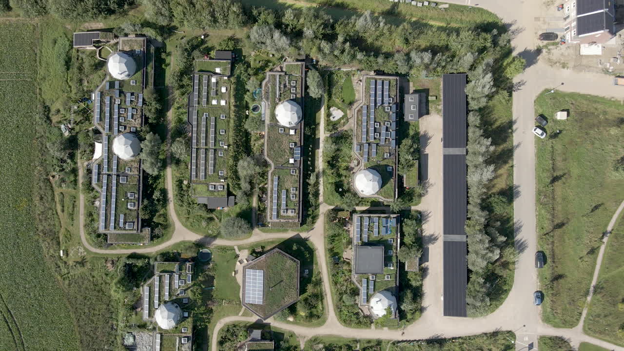 Top down aerial of beautiful green earthship community