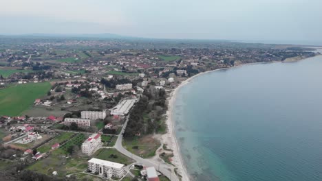 Aerial-Drone-Shot-beach-coastline-next-to-city-cloudy