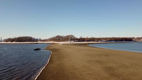 Winter-snowy-scene,-wetlands-against-cityscape,-Squantum,-Massachusetts