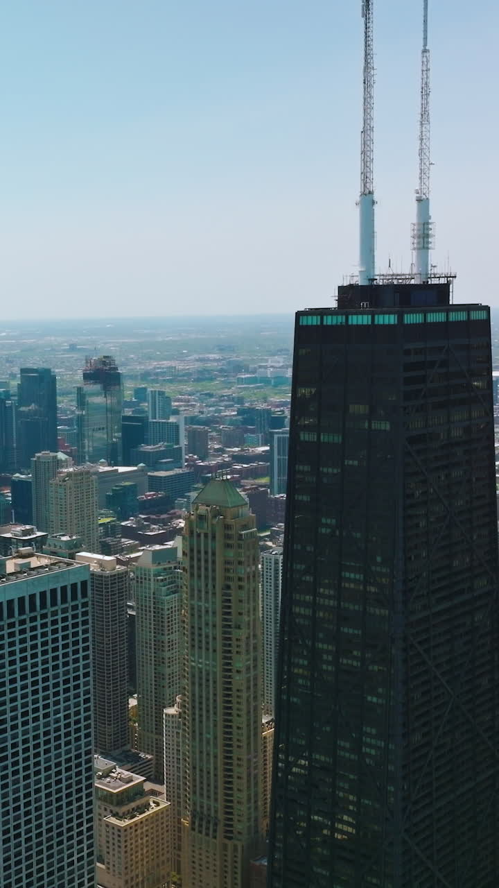 Outstanding skyscrapers towering over the modern city. Scenic panorama of Chicago at the background of blue sky. Vertical video