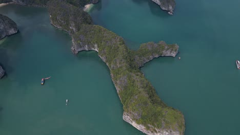 limestone-cliff-islands-spill-into-bright-blue-water-in-cove-at-Cat-Ba-and-Halong-Bay-in-Northern-Vietnam