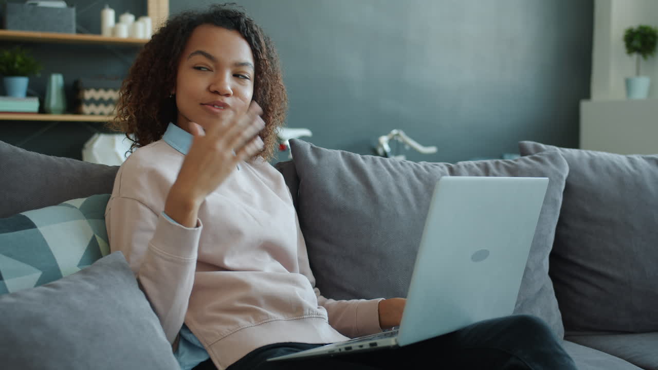 Woman Video Conferencing on Couch