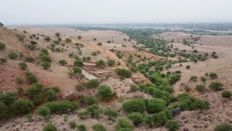 Aerial-of-Ruined-Stoned-House-in-The-Middle-of-Hills