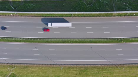 overhead aerial of traffic flowing in opposite directions on highway