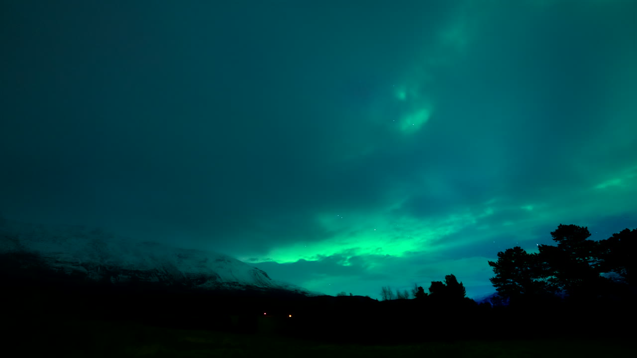 Magical polar lights aurora borealis dancing in Norwegian night sky, time-lapse