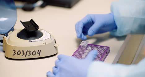 Scientist-Putting-Test-Tubes-With-Bacteria-In-Shaker-At-Laboratory